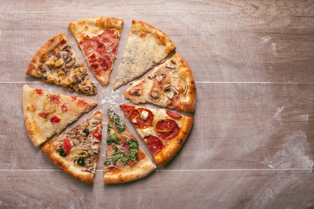 An eight-slice pizza with different toppings on each piece. 