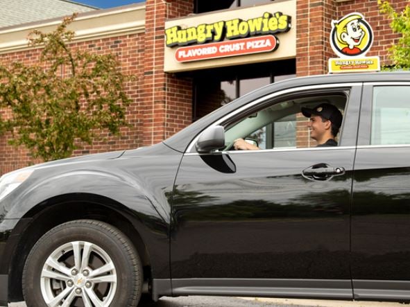 Pizza Delivery Driver In Front of Hungry Howie's