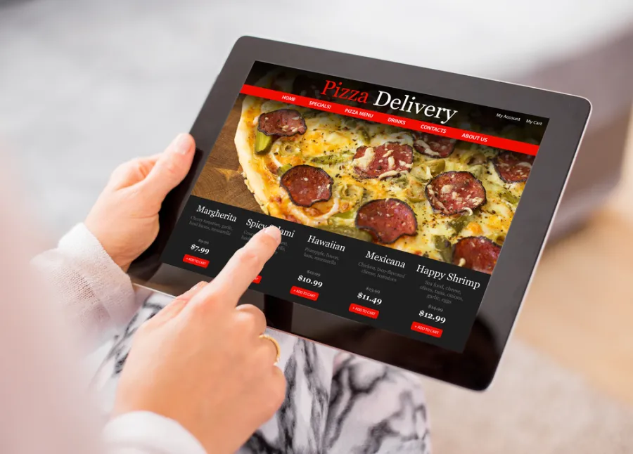 Lady ordering pizza online through her mobile tablet